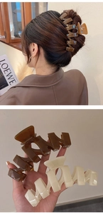 Detail showing 13cm oversized hollow geometric hair claws in brown and cream finishes
