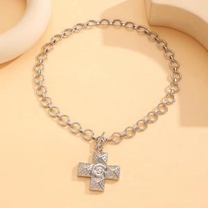 Detail view of silver necklace with swirl texture cross pendant and T-bar toggle clasp