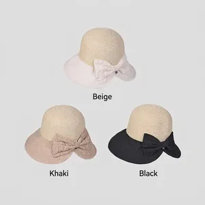 Women's woven bucket hats with bow decoration in beige, khaki, and black colors