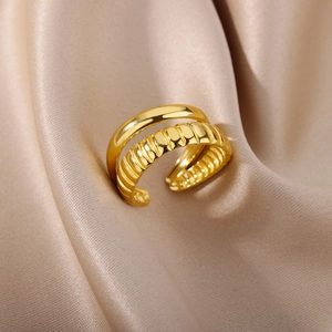 Macro detail of 18k gold plated double layer ring with croissant texture on silk background