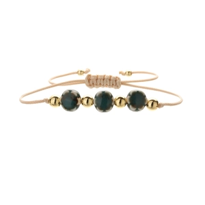 Detail of adjustable woven bracelet with green floral ceramic beads and gold spacers