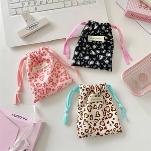 Cute leopard heart print drawstring pouches in pink black and beige for cosmetics