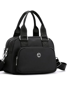 Black nylon handbag with silver hardware and detachable strap for a versatile daily look