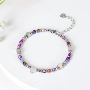 Bohemian stainless steel beaded bracelet with natural stones and heart pendant on white background