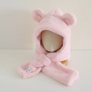 Close-up of pink plush hooded scarf with bear ears and woven detail label for kids
