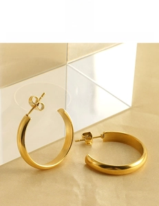 Detail of 18K gold plated C-shape hoop earrings showing lead and nickel free materials