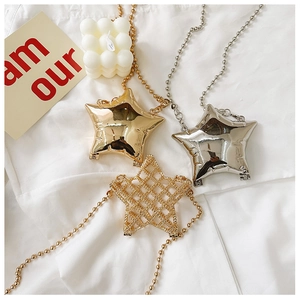 Detailed view of star-shaped mini bags in gold and silver finishes with bead chains