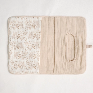 Detail of baby crib organizer showing floral quilted cotton and baby wipes dispenser pocket