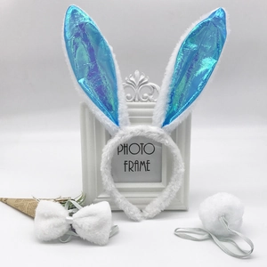 Detailed set of white plush rabbit ears with blue sequin inlay, bow tie, and fluffy tail