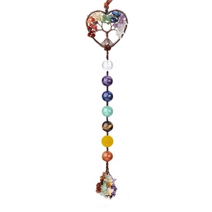 Macro view of heart-shaped Tree of Life pendant with seven chakra stones and tassel
