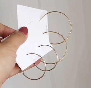 Detail of 1.2mm gold and silver minimalist hoop earrings with 925 sterling silver posts