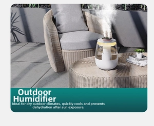Close-up of portable humidifier with dual spray nozzles and warm ambient light outdoors