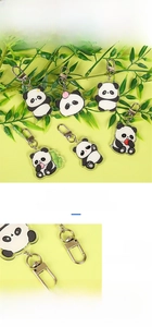 Detail showing acrylic panda keychains with double-sided film and aluminum alloy clips