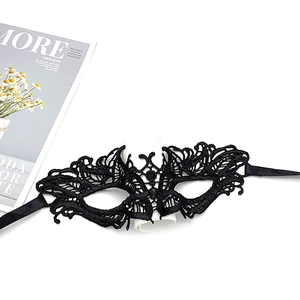Detailed close-up of a black lace party mask on a white background for Halloween events