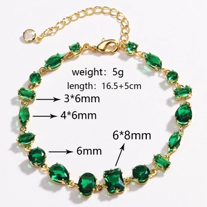 Detail showing gold bracelet with green zircons and precise length measurements