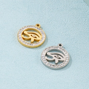 Gold and silver Eye of Horus pendants with cubic zirconia crystals in a circular design