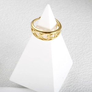 Minimalist gold hollow heart open ring displayed on a white pyramid stand for women