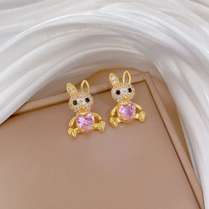 Detail of gold bunny earrings with pink heart gemstones and micro-pave zircons