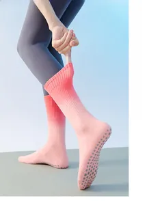 Detail of pink gradient yoga socks with grey anti-slip silicone grippers on the sole