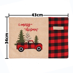 Christmas placemat detail with red truck embroidery and classic red-black plaid pattern