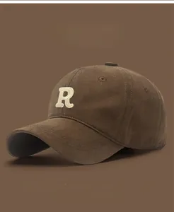 Detail of vintage baseball cap featuring premium white towel embroidery R letter on brown cotton