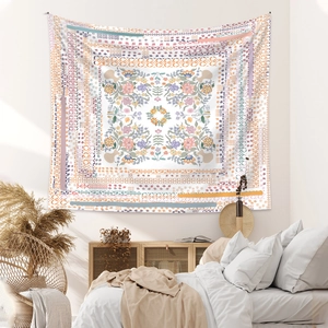 Detailed close-up of a large bohemian tapestry with symmetrical floral and mandala patterns