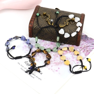 Detailed set of four handmade woven bracelets featuring colorful heart-shaped natural stones