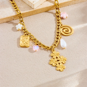 Gold plated stainless steel necklace with clover, butterfly, and pearl charms on stone