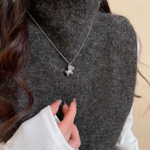 Chic silver poodle pendant necklace with zircon on elegant dark grey knitwear