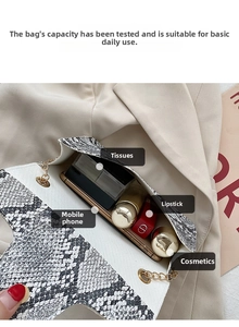 Interior view of snakeskin pattern crossbody bag showing capacity for phone and cosmetics
