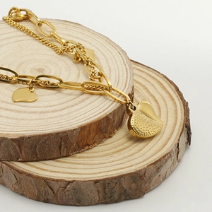 Double-layered 18k gold plated stainless steel heart charm bracelet on wood slices