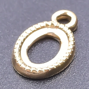 Detailed close-up of a golden 18k plated stainless steel oval letter O pendant for DIY jewelry