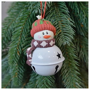 Close-up of snowman bell ornament with knitted hat and scarf on a Christmas tree
