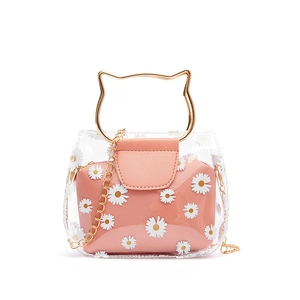 Transparent PVC daisy handbag with golden cat-ear handles and pink inner pouch