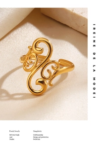 Detail of gold-plated stainless steel ring featuring intricate openwork scroll patterns