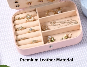 Pink jewelry box detail showing partitioned velvet interior for rings and necklaces
