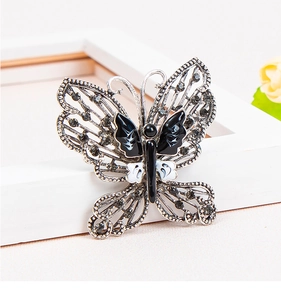 Detailed view of butterfly brooch with rhinestones and enamel on vintage silver metal