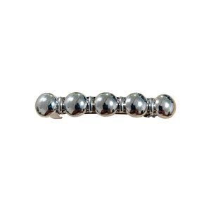 Polished silver metal hair clip with five continuous spheres in a modern minimalist style