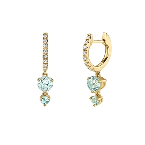 Close-up of gold earrings with micro-pave diamonds and blue zircon round drop details