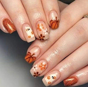 Close-up of Halloween press-on nails with hand-painted pumpkins and ghost patterns