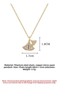 Detail view of gold ginkgo leaf pendant with micro-inlaid stones and chain specifications