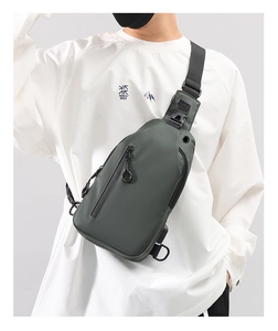 Detail of grey-green waterproof men's crossbody chest bag with adjustable strap and D-ring