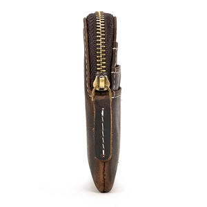 Detailed side view of a brown genuine leather wallet featuring vintage brass zippers