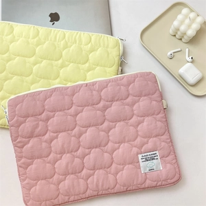 Detailed view of quilted cloud laptop sleeve with soft texture and side handle