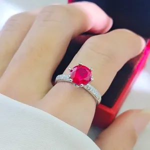 Luxurious 2-carat red ruby ring in six-prong setting on model's hand with gift box