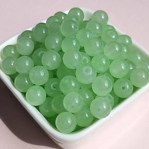 8mm light green glass round beads for DIY jewelry making in a white square tray