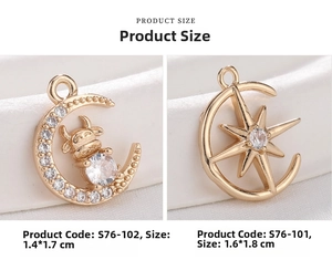 Close-up of 18K gold plated moon and star pendants with inlaid cubic zirconia crystals