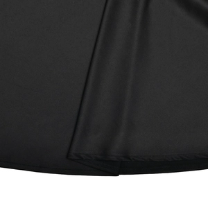 Detailed close-up showing the smooth black fabric texture and neat hemline stitching of the dress