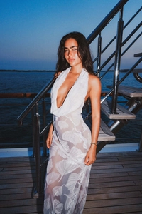Detail of sheer white halter maxi dress with silver ginkgo leaf jacquard patterns
