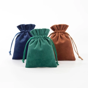 Three premium velvet drawstring pouches in navy blue, dark green, and brown for jewelry